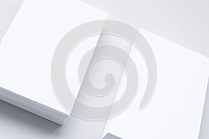 Two blank business card stacks, poster, letterheads isolated on white as template for design presentation, mock-up etc