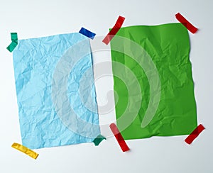 Two blank crumpled sheets of paper glued with rubber colored adhesive tape