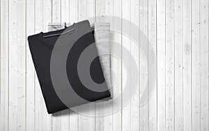 Two blank jumpers lying on white wood background