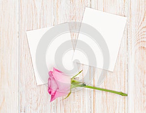 Two blank photo frames and pink rose