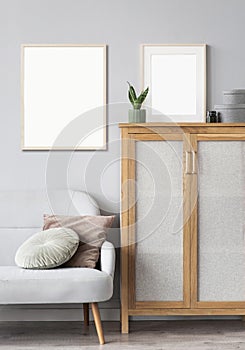 Two blank picture frames mockup on gray wall. Templates for painting or poster. White living room interior design.