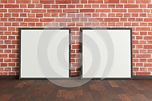 Two blank square posters. frame mock up standing on dark parquet floor next to red brick wall.