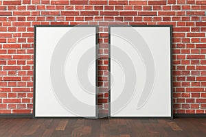 Two blank vertical posters. frame mock up standing on dark parquet floor next to red brick wall. Clipping path around posters.