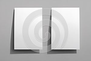 Two Blank White Papers on a Gray Background