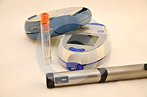 Two Blood Glucose Meters and Insulin Pen photo