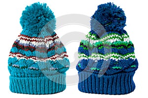 Two blue bobble winter knit ski hat isolated white