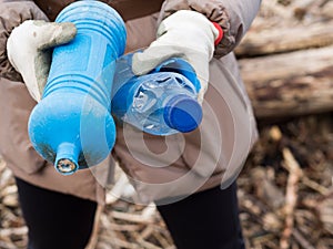 Two blue bottles in the hands of a volunteer photo