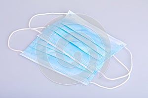 Two blue disposable face masks on white background.