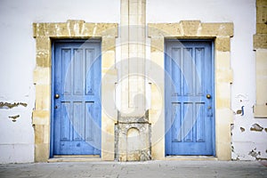 Two blue doors in a southern style building