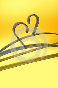 Two blue hangers on yellow background