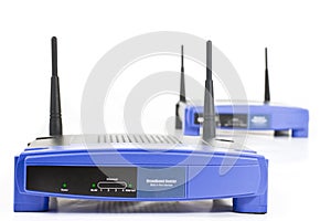 Two blue internet router with two antennas