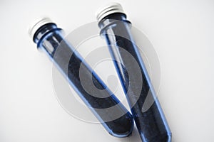 Two blue plastic flasks with a shiny lid. Flasks with tea inside