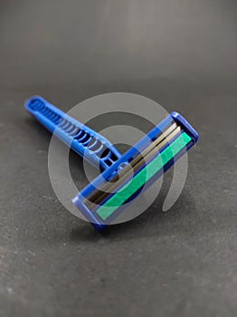 Two blue shavers isolated on a black