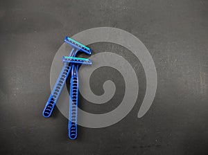 Two blue shavers isolated on a black