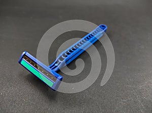 Two blue shavers isolated on a black