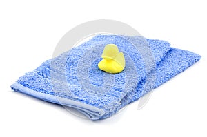 Two blue washcloth with yellow soap duck