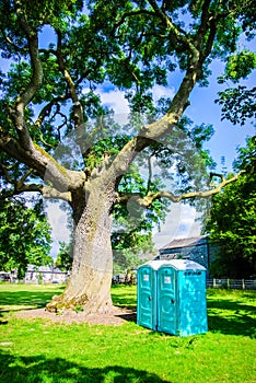 Two blue - white portable toilet cabins at outside event UK