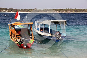Two boats on blue waves in the ocean. Tropical Gili islands.