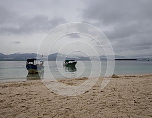 Two boats close two the beach at San Blas Panama photo