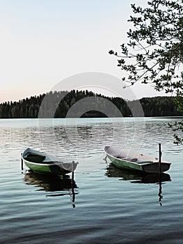 Two boats, fishing two-shift water transport of green color on a leash