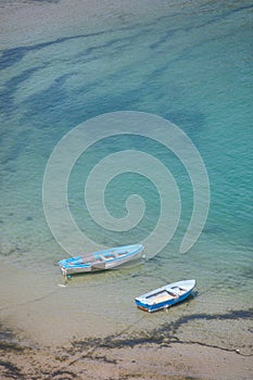 Two boats floating on blue water