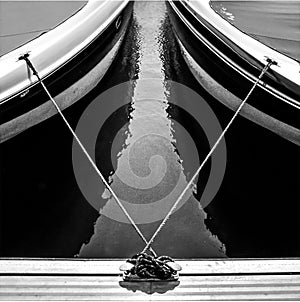 Tensed ropes in V between boats photo