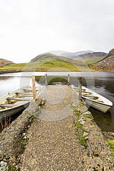 Two boats and jetty, north Wales, portrait