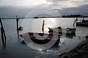 Two boats moored in the Comacchio canal.