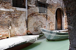 Two boats in the narrow channel of water a milky green.