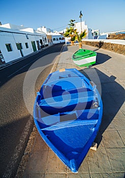 Two boats and palm on the coast.