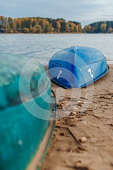 Two boats on the sandy bank of the river. Forest in the background.