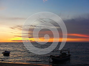 Two boats by the sea against sunset, Pinang, Malaysia