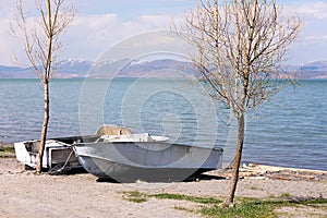 Two boats on shore of Lake Sevan in spring