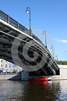 Two boats under bridge
