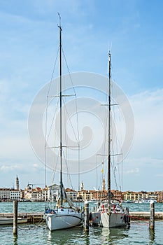 Two boats and yachts anchored at the San Giorgio Maggiore Yacht Harbor in Venice, Italy