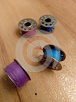 Four bobbins are placed on the floor