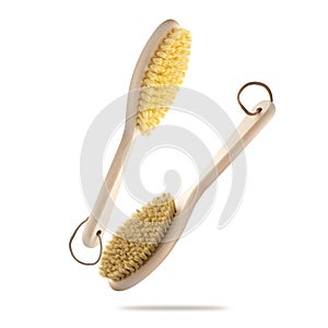 Two body brushes float on a white background. Massage brushes made of boar bristles and cactus bristles on a white background.