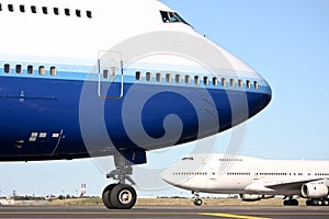 Two Boeing 747 jumbo jets on the runway.