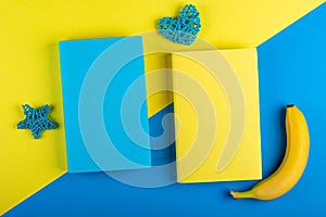 Two books Mock up and a banana on a yellow-blue background