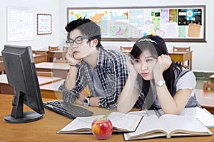 Two bored student studying in the class
