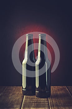 Two bottle of beer on a dark background/Two bottle of beer on a dark background. Toned