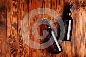 Two bottles of beer lie on an open table with empty space
