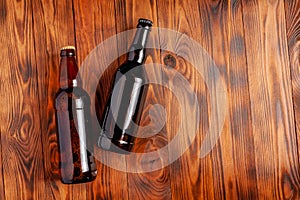 Two bottles of beer lie on an open table with empty space