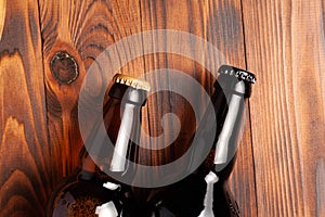Two bottles of beer lie on an open table with empty space
