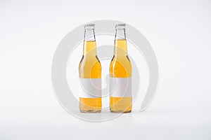 Two bottles of beer with white blank labels on white background.