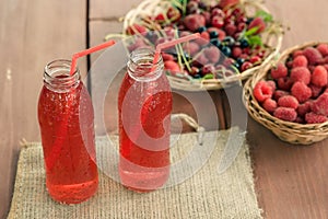 Two bottles of cold stewed fruit from assorted berries.