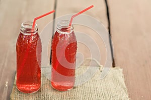 Two bottles of cold stewed fruit from assorted berries.