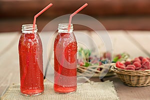 Two bottles of cold stewed fruit from assorted berries.