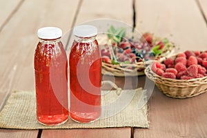 Two bottles of cold stewed fruit from assorted berries.