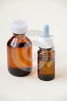 Two bottles of dark glass liquid medicine